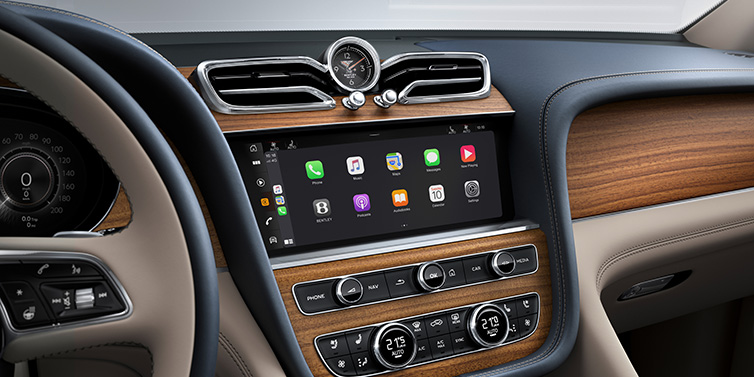 Bentley Busan Bentley Bentayga Extended Wheelbase Azure SUV front interior centre console with MMI screen showing apps, surrounded by Portland and Imperial Blue coloured hides